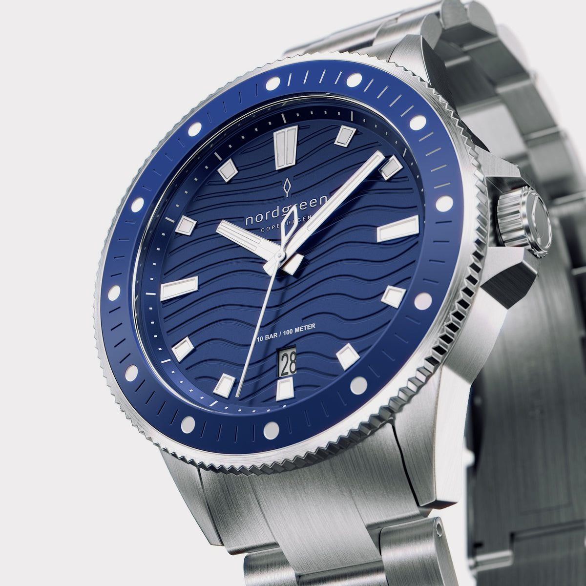 Angled view of the blue bezel with white dots and the brushed bracelet.