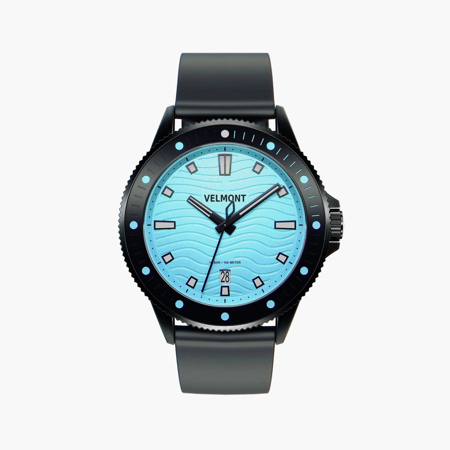 Black diver-style watch with a light turquoise wave-patterned dial and dark strap.