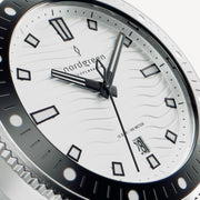 Close-up of the white wave dial with black-outlined indices and date window.