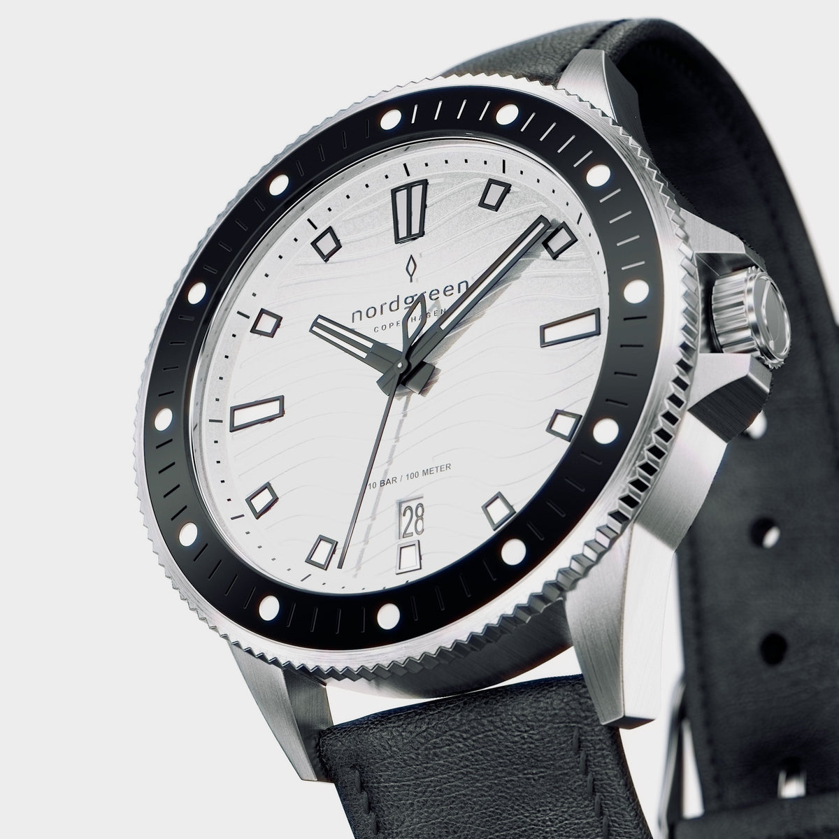 Angled view of the silver-tone case, knurled crown and dotted black bezel.