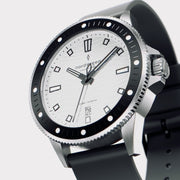 Angled view of the silver-tone case with black bezel and white dial.