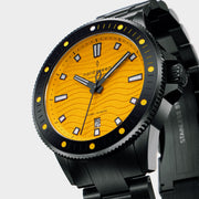 Angled view of the yellow dial and black coin-edge bezel with yellow dots.