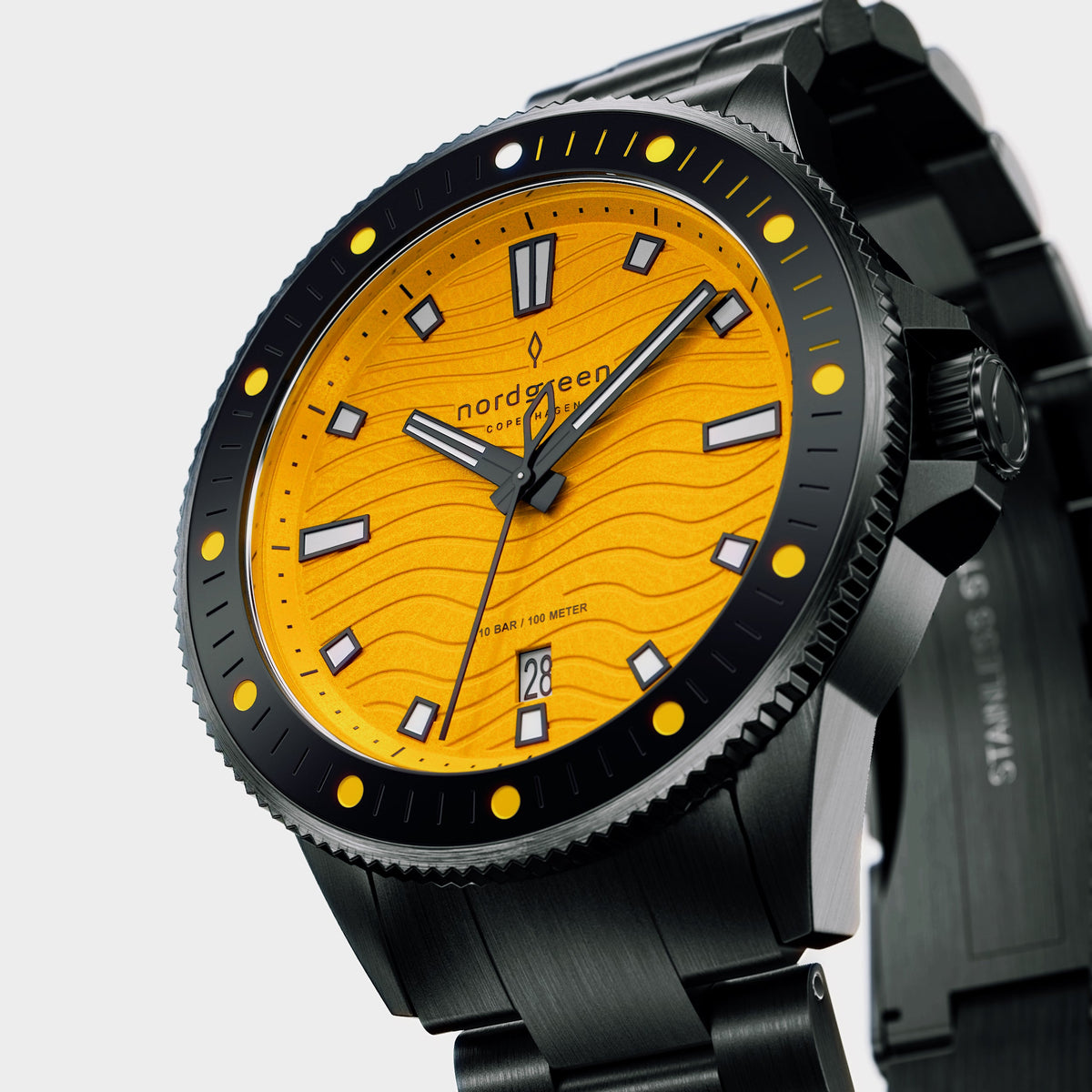 Angled view of the yellow dial and black coin-edge bezel with yellow dots.