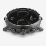 Side profile of the gunmetal case showing the crown flanked by two pushers.