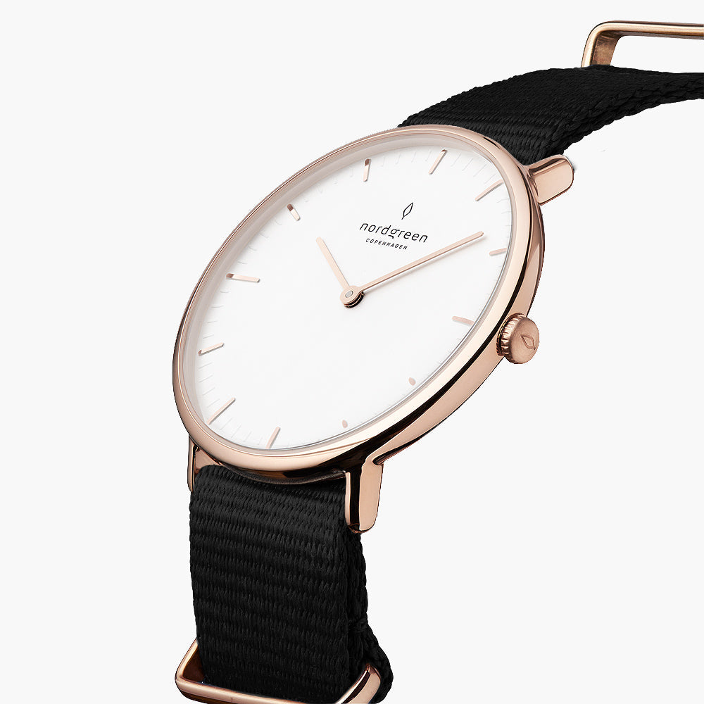 Three-quarter view of the thin rose gold-tone case on a black fabric strap.