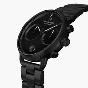 Angled view of the black dial, white-accented hands and black pushers.
