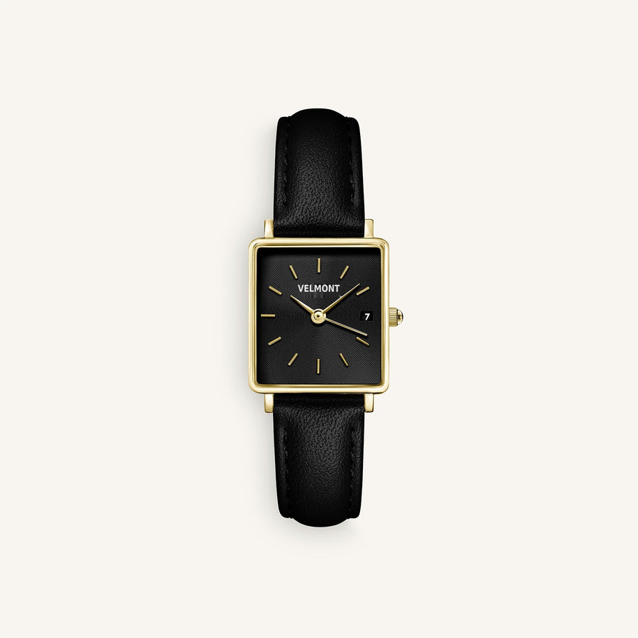Gold-tone square watch with black dial and black strap, front view