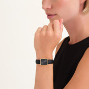 Black square watch worn at the chin