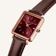 Close-up of the burgundy sunray dial and date window