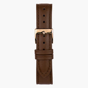 Detached brown strap fastened with a rose gold-tone pin buckle.