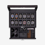 Twelve-slot watch box with open glass lid and accessory drawer with sunglasses and straps