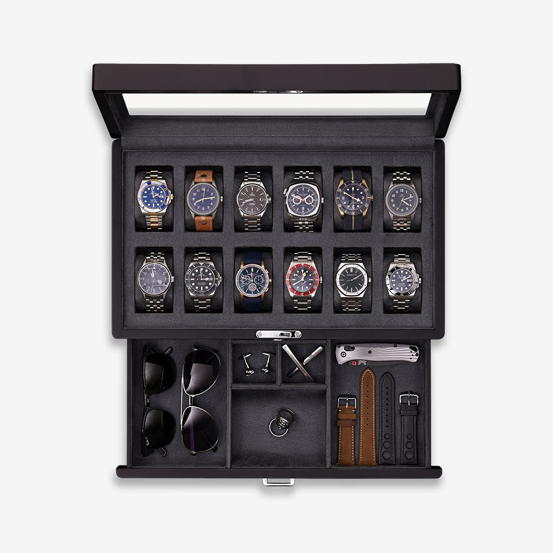 Twelve-slot watch box with open glass lid and accessory drawer with sunglasses and straps