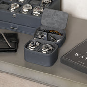 Two-watch travel case open next to a watch box and wallet