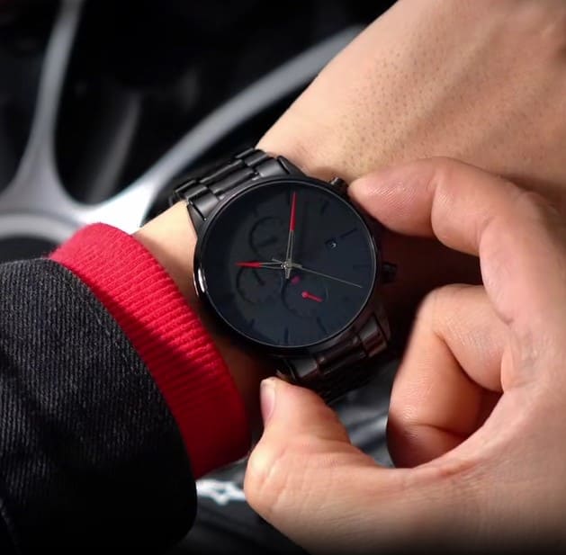 Red accent watch held in a car
