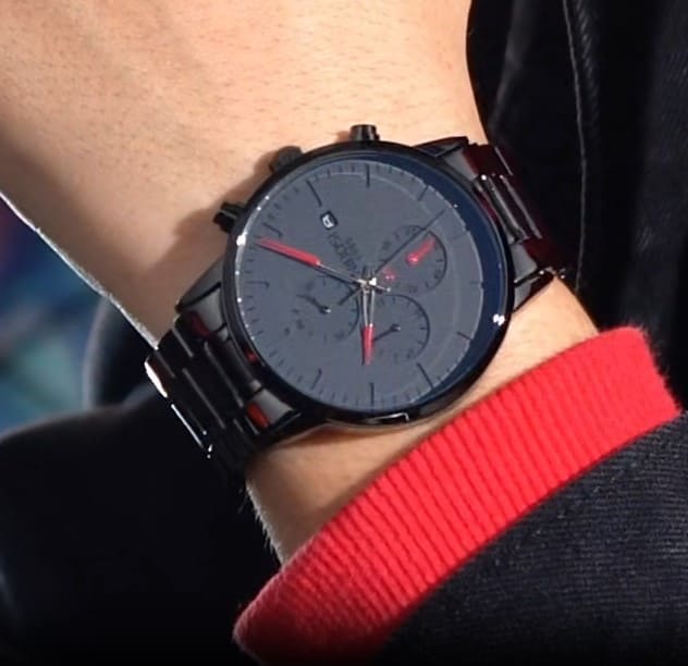 Red accent watch on a wrist with red sleeve