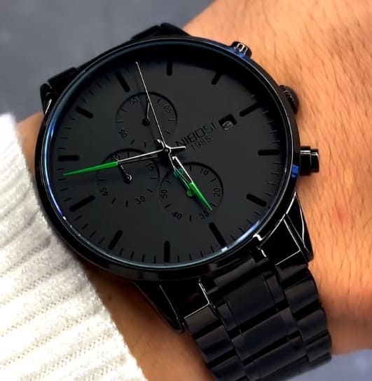 Green accent watch close up on the wrist