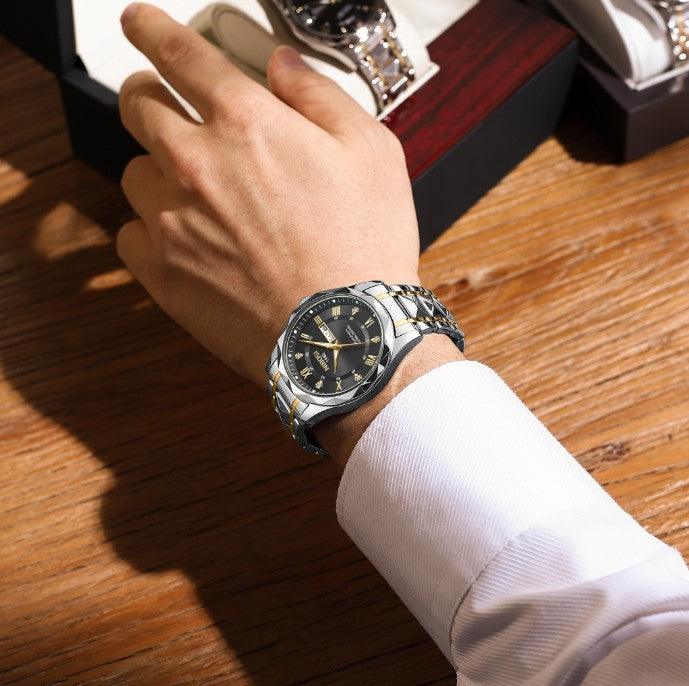 Two tone watch on a wrist at a desk