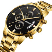 Gold-tone black dial watch at an angle