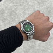Green dial watch on the wrist