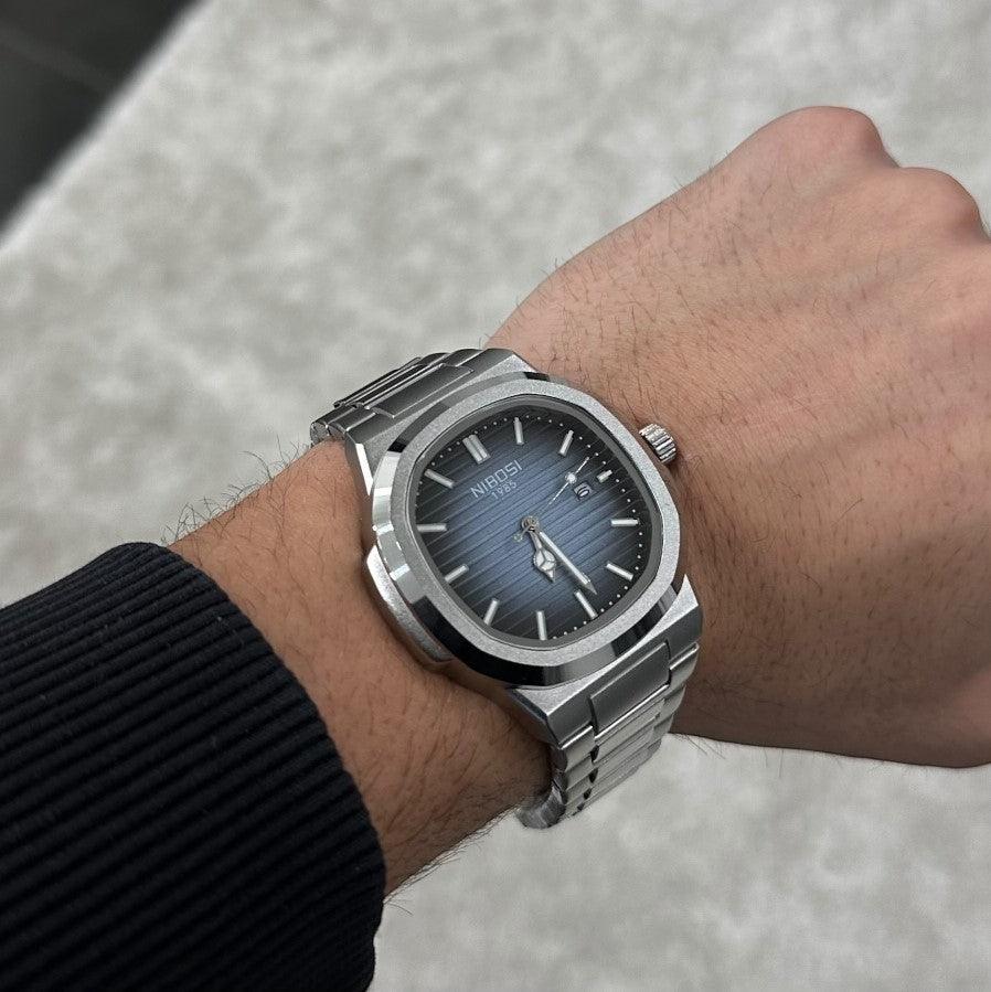Blue dial watch on the wrist