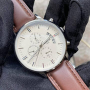 White dial chronograph on the wrist, close up