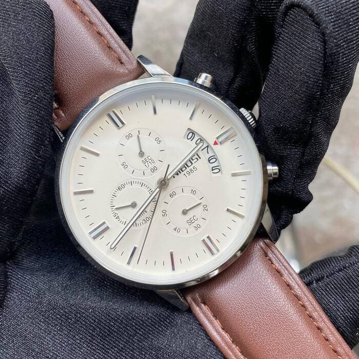 White dial chronograph on the wrist, close up