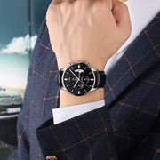 Black dial chronograph on the wrist with a black strap