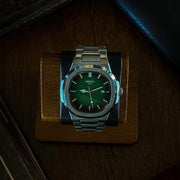 Green dial watch in a lit display box