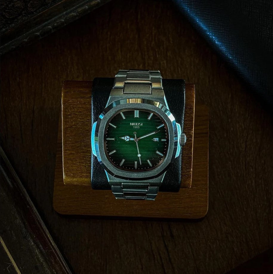 Green dial watch in a lit display box