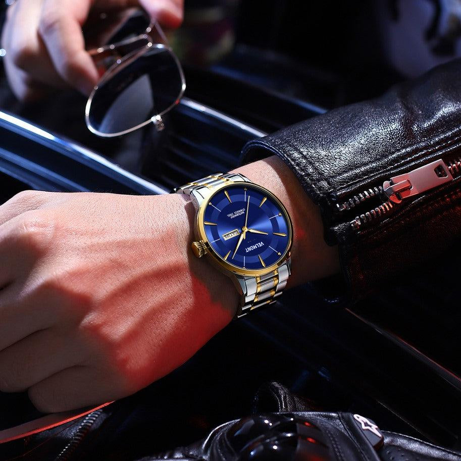 Blue dial watch on a wrist in a car