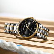 Two tone watch on wood and rope