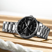 Steel watch on a wooden surface