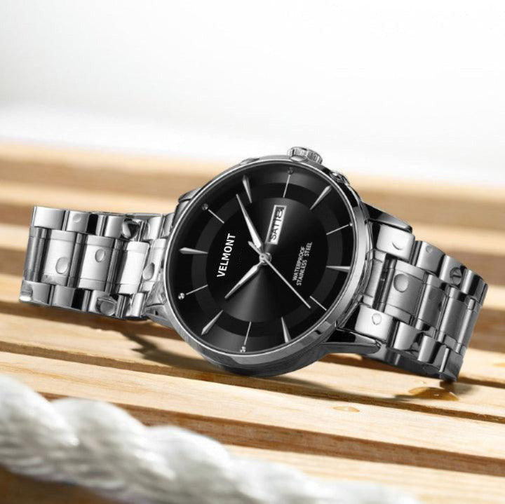 Steel watch on a wooden surface