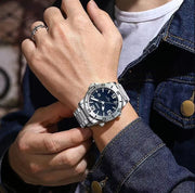 Blue dial watch on a denim sleeve