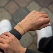 Gold-tone rope chain bracelet on the wrist