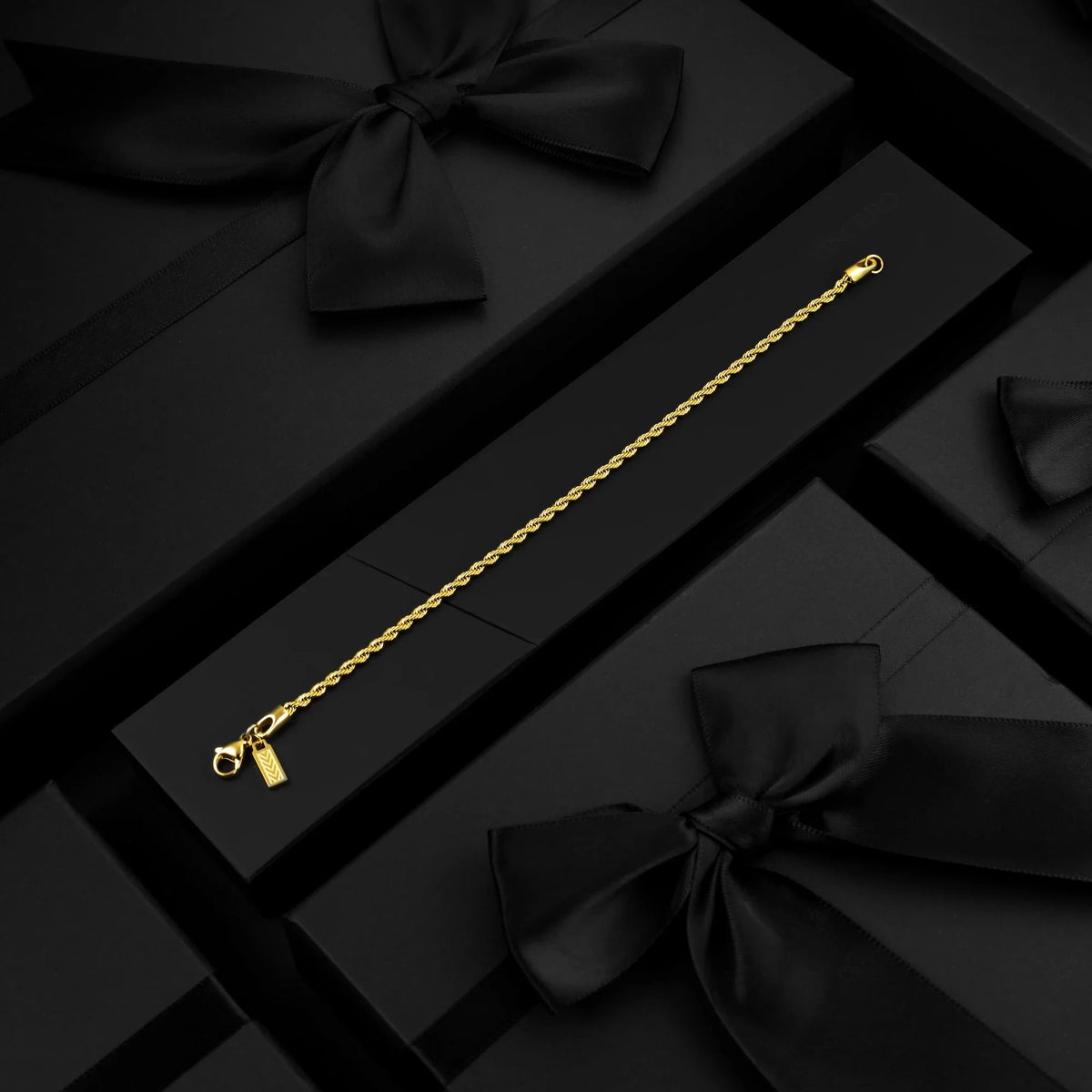 Gold-tone rope chain bracelet in a black gift box
