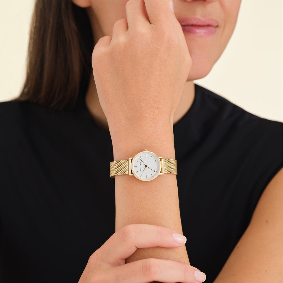 Mesh strap watch worn with a black top