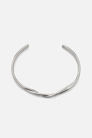 Silver-tone wavy crossover cuff, front view on a light background