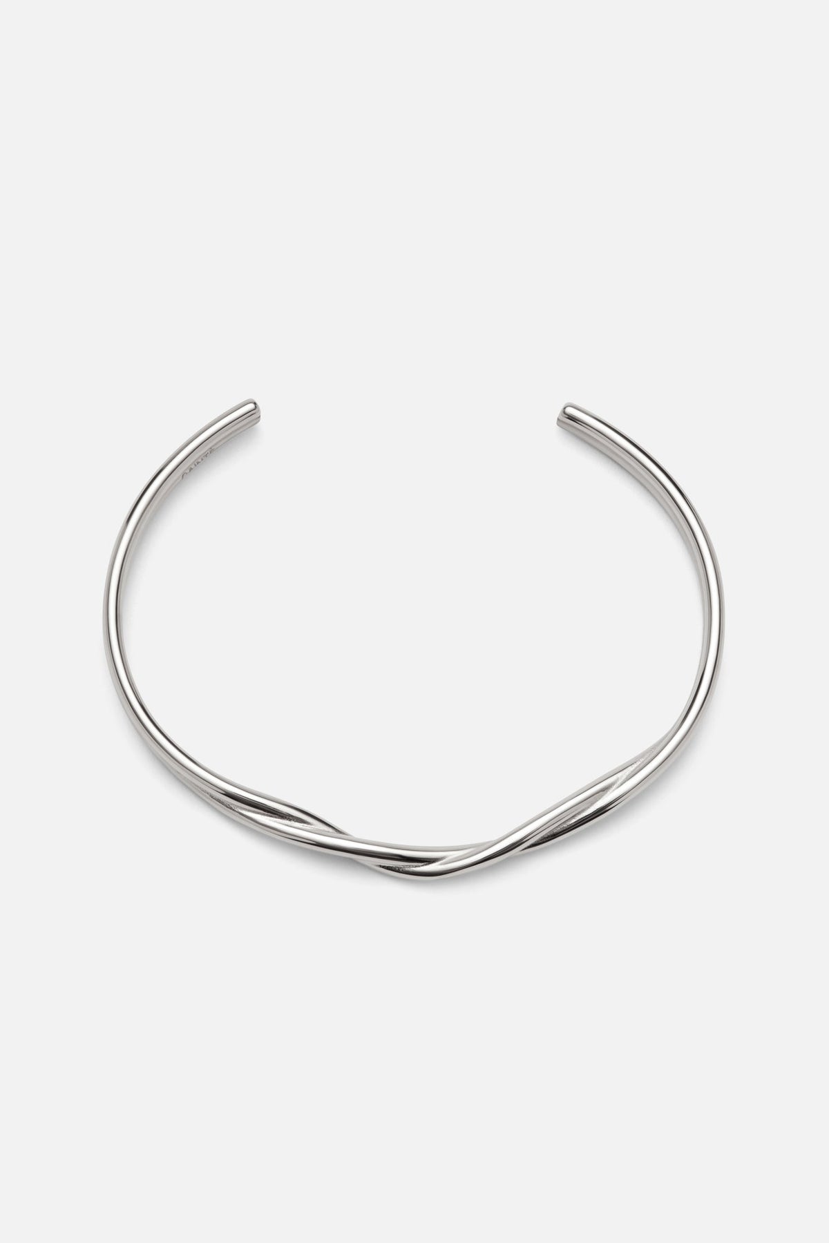 Silver-tone wavy crossover cuff, front view on a light background
