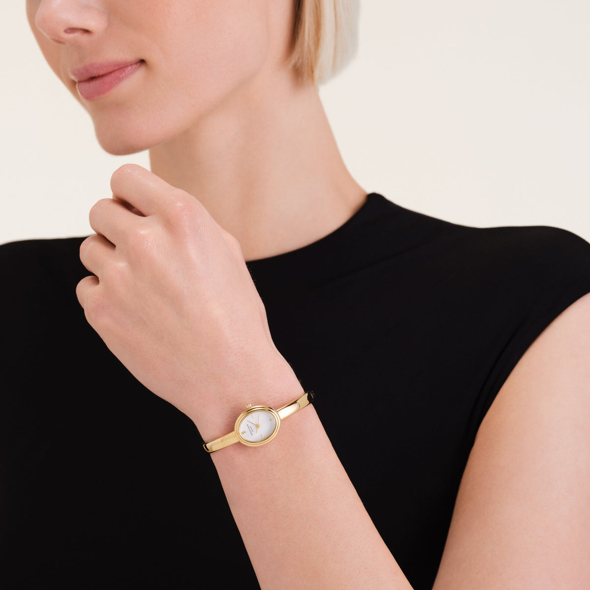 Bangle watch worn with a black top