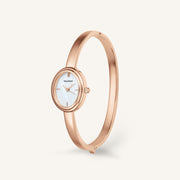 Rose gold-tone bangle watch standing upright