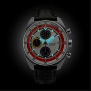 White chronograph glowing in low light