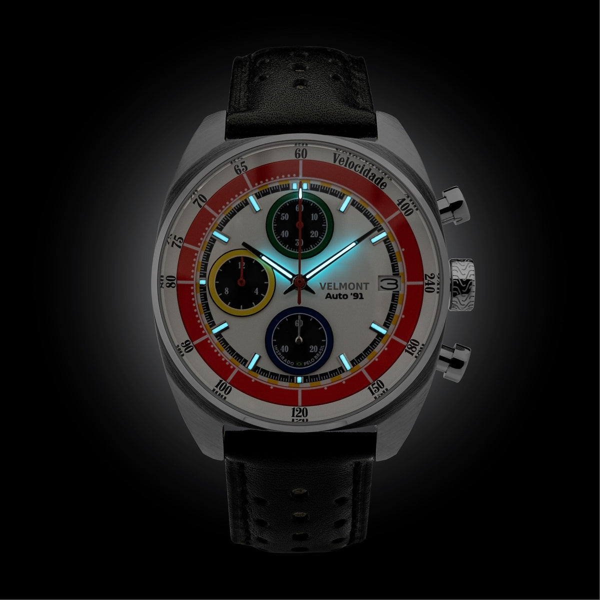 White chronograph glowing in low light