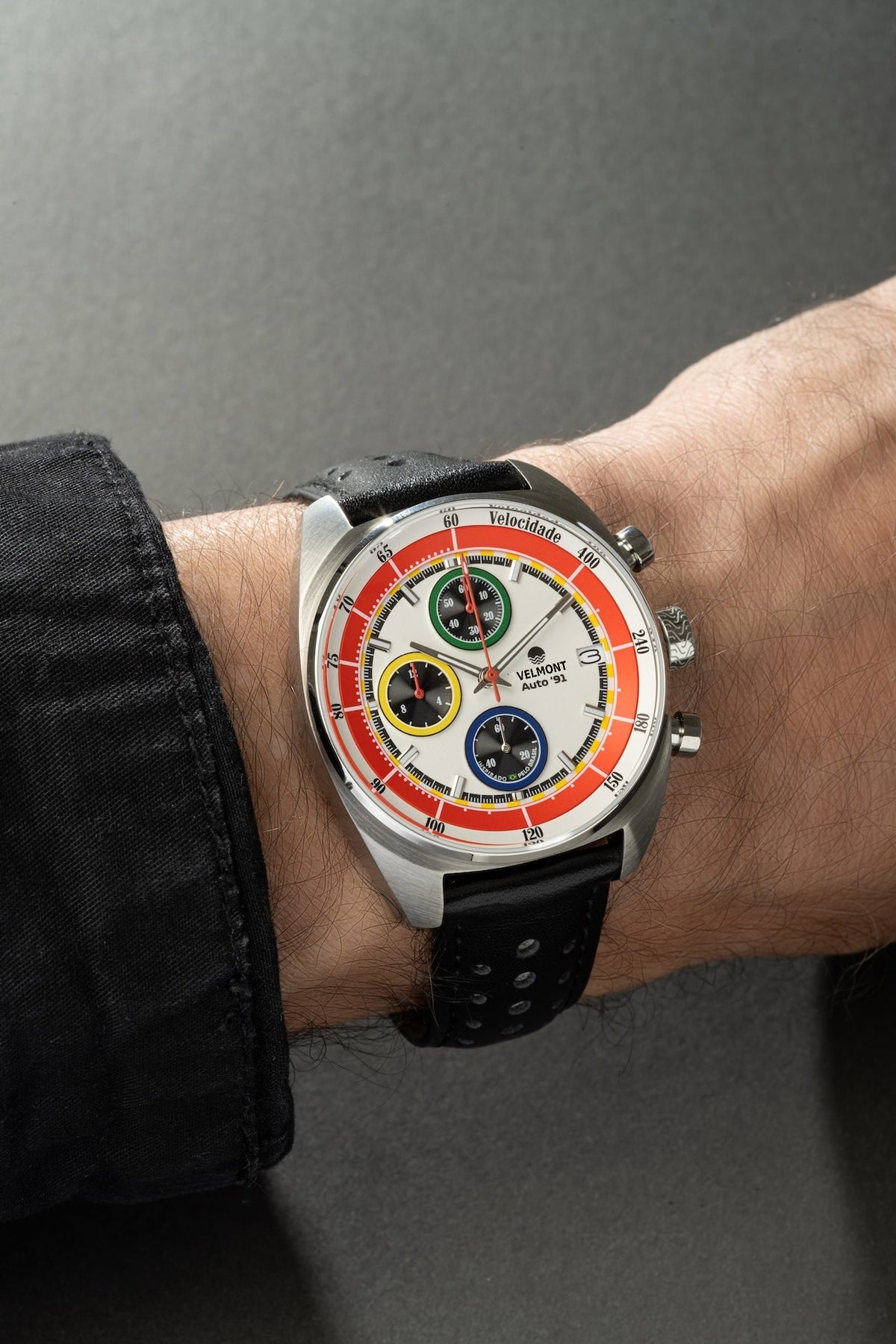 White chronograph on the wrist with a black strap