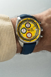 Yellow chronograph on the wrist with a blue strap