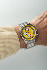 Yellow chronograph on the wrist with a bracelet