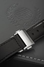 Black strap and buckle on an embossed surface