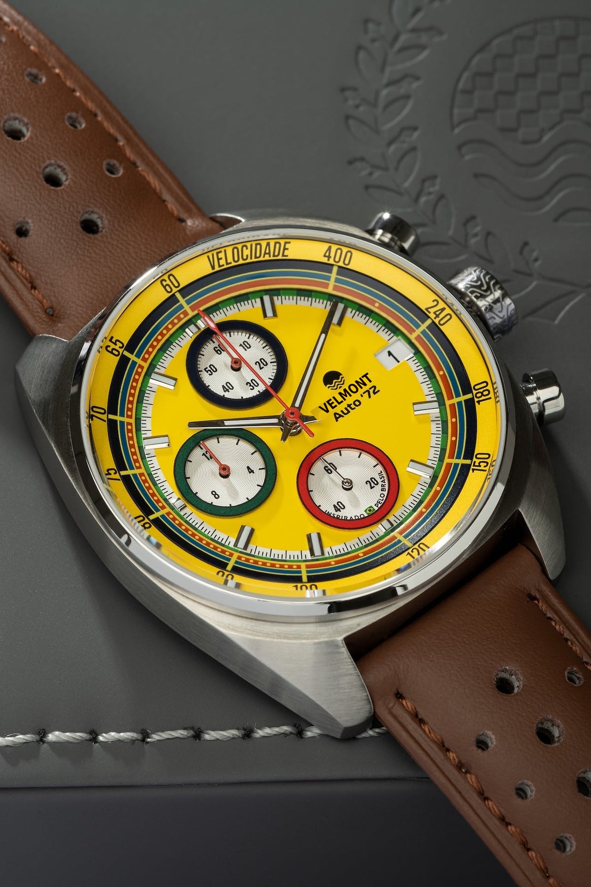 Yellow chronograph on brown strap at an angle