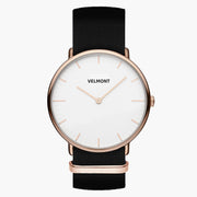 Watch with a white dial and rose gold-tone case on a black woven strap.