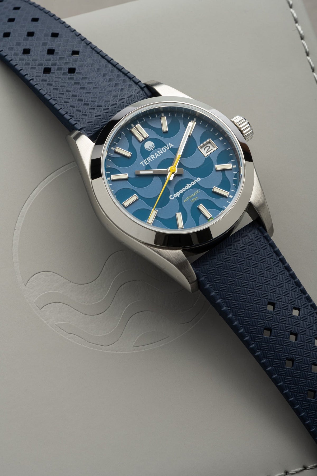 Blue dial watch on blue strap at an angle